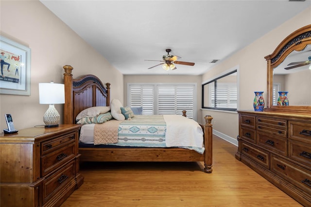 bedroom with light wood-type flooring, baseboards, visible vents, and ceiling fan