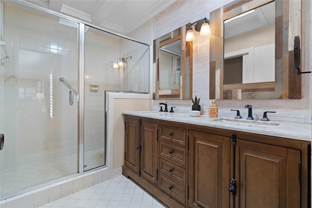 bathroom with a stall shower, tile patterned floors, a sink, and double vanity