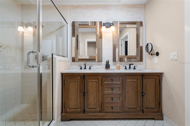 full bath featuring a sink, a shower stall, and double vanity