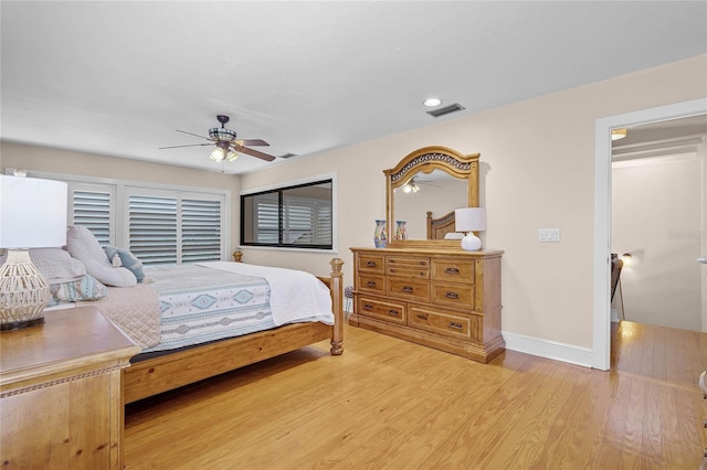 bedroom featuring baseboards, ceiling fan, visible vents, and light wood finished floors