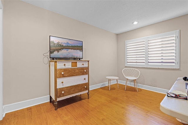 sitting room featuring baseboards and wood finished floors