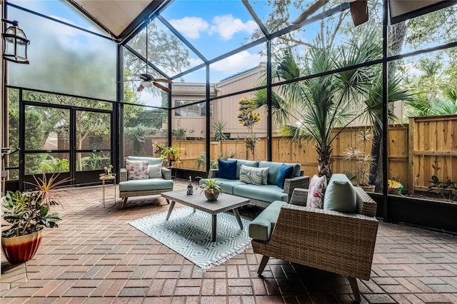 view of patio / terrace featuring glass enclosure, a fenced backyard, and outdoor lounge area