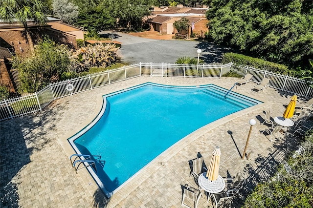 pool with fence and a patio