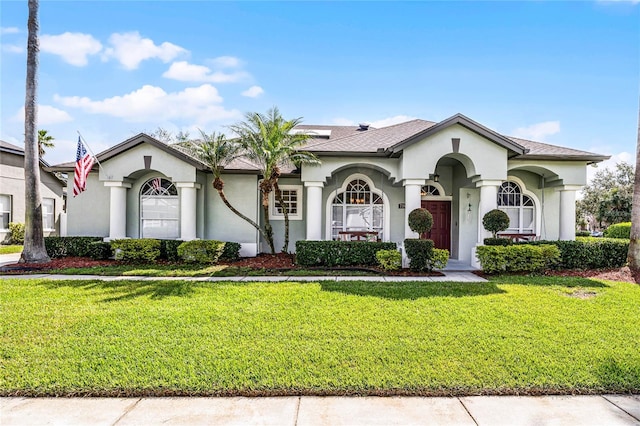 mediterranean / spanish-style house featuring a front yard and stucco siding