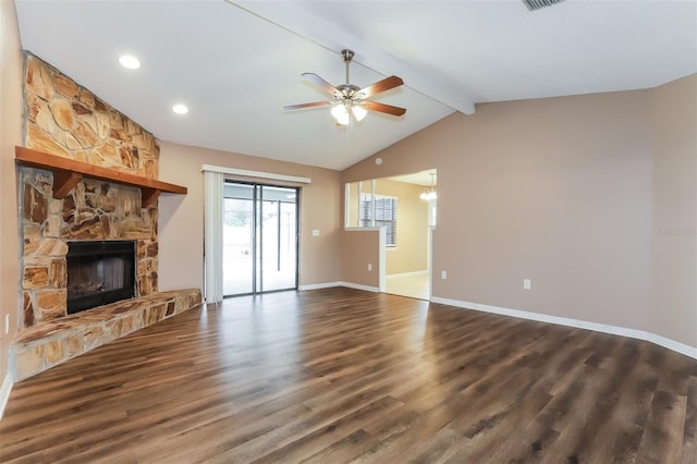 unfurnished living room with vaulted ceiling with beams, dark wood-type flooring, a ceiling fan, a stone fireplace, and baseboards