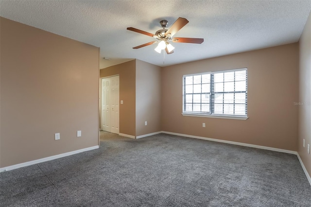 spare room featuring carpet floors, ceiling fan, baseboards, and a textured ceiling