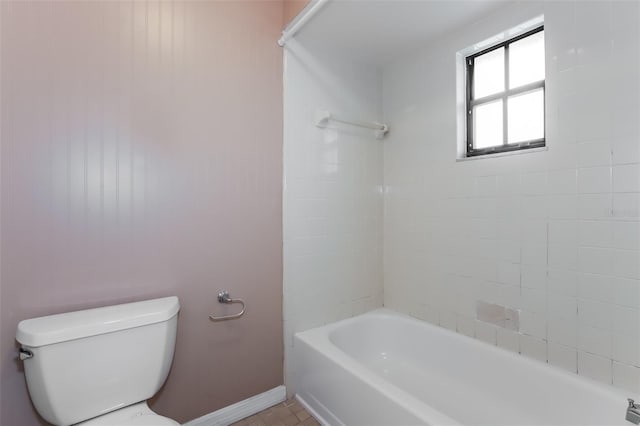 full bath featuring toilet, bathtub / shower combination, and baseboards