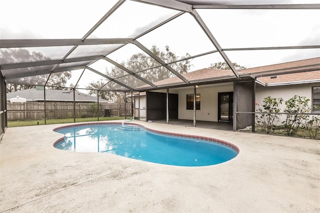 view of pool featuring a fenced in pool, glass enclosure, a patio, and fence