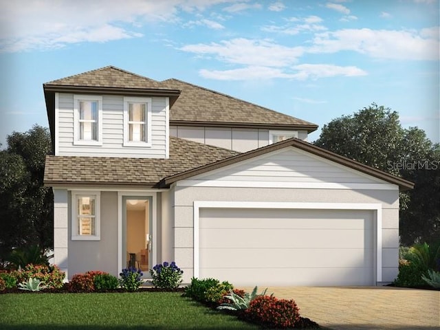 traditional-style house featuring roof with shingles, stucco siding, a garage, driveway, and a front lawn