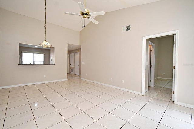 spare room with visible vents, baseboards, ceiling fan, high vaulted ceiling, and light tile patterned flooring