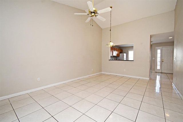 spare room featuring high vaulted ceiling, baseboards, a ceiling fan, and light tile patterned flooring