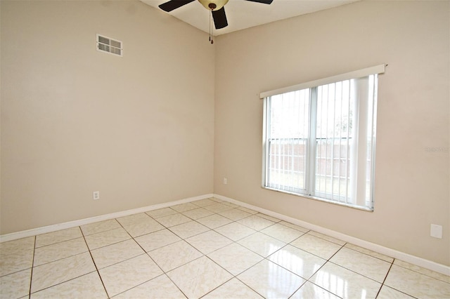 empty room featuring a ceiling fan, visible vents, baseboards, and light tile patterned floors