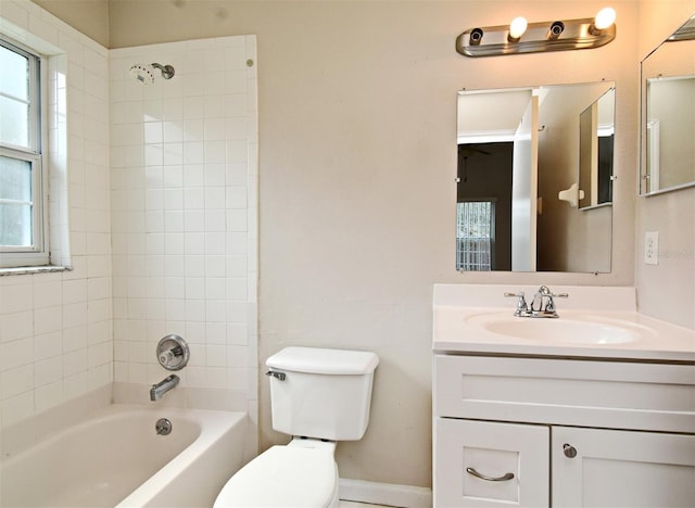 bathroom featuring shower / bathtub combination, vanity, toilet, and baseboards