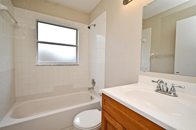 bathroom with washtub / shower combination, vanity, and toilet