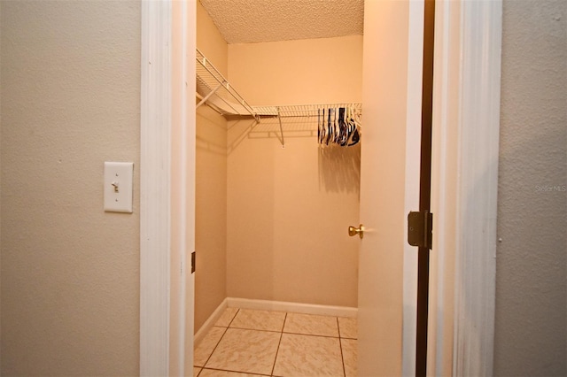 spacious closet featuring light tile patterned floors