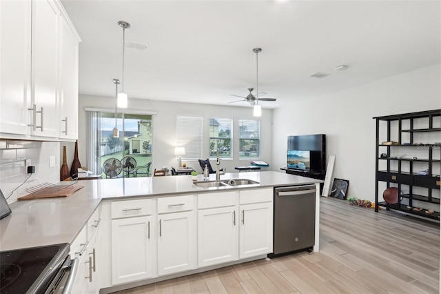 kitchen with dishwasher, a peninsula, a sink, and light wood-style floors