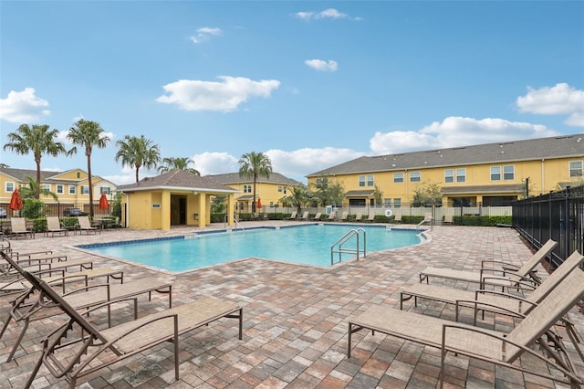 community pool featuring a patio area and fence