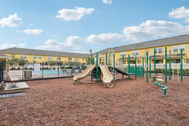 community playground featuring a residential view and fence