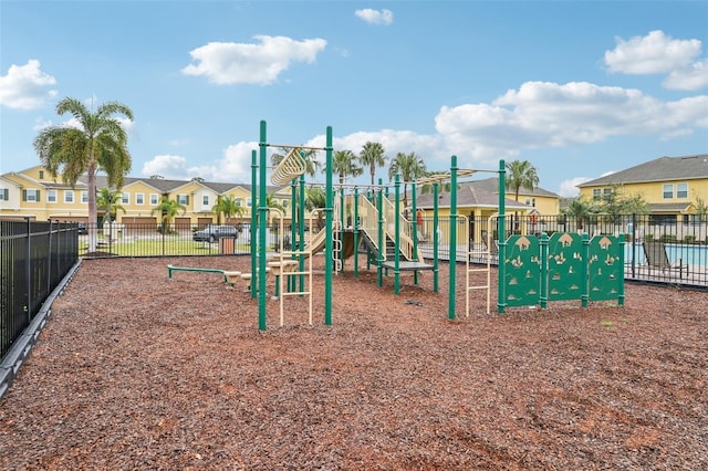 community playground with a residential view and fence