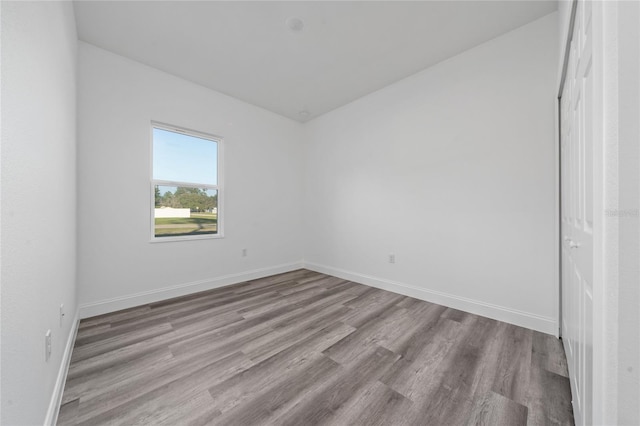 unfurnished bedroom with light wood-type flooring and baseboards