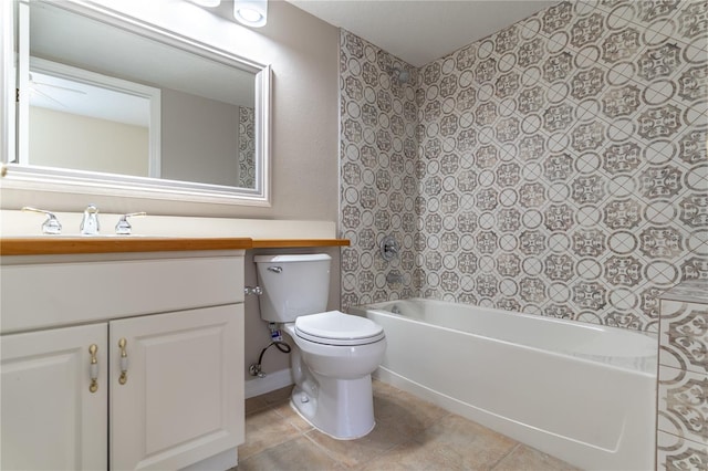 bathroom featuring toilet, vanity,  shower combination, and tile patterned flooring