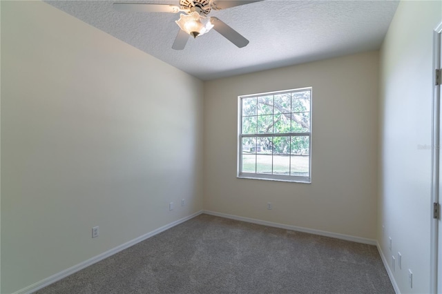 carpeted empty room with baseboards, a textured ceiling, and a ceiling fan