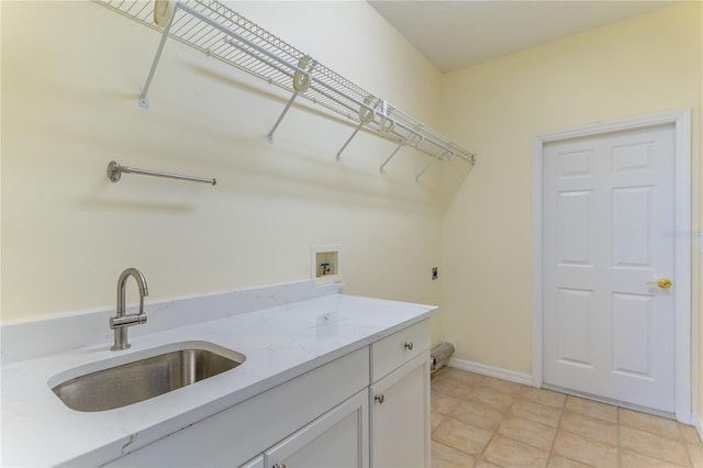 washroom featuring washer hookup, baseboards, a sink, hookup for an electric dryer, and cabinet space