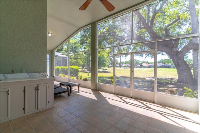 unfurnished sunroom with a ceiling fan