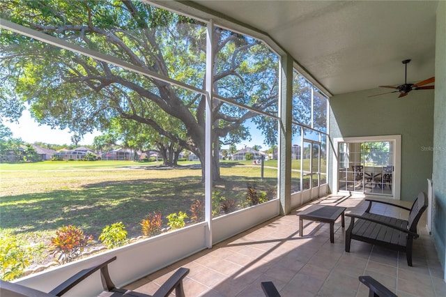 sunroom / solarium featuring a ceiling fan
