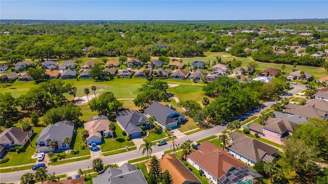 bird's eye view featuring a residential view, golf course view, and a wooded view
