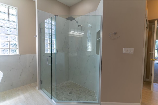 bathroom featuring a marble finish shower
