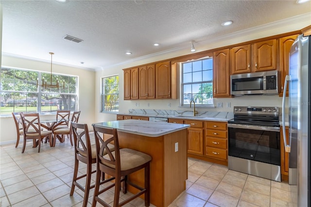 kitchen featuring brown cabinets, a sink, and stainless steel appliances