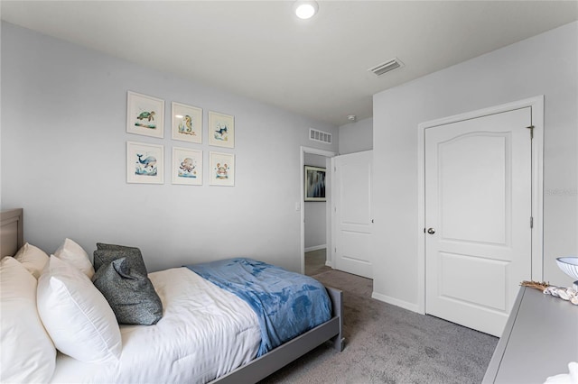 carpeted bedroom featuring visible vents and baseboards