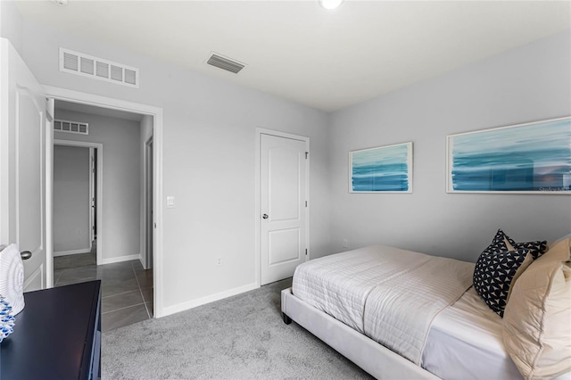 bedroom with carpet floors, visible vents, and baseboards