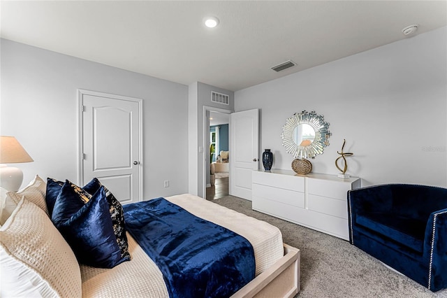 carpeted bedroom featuring visible vents