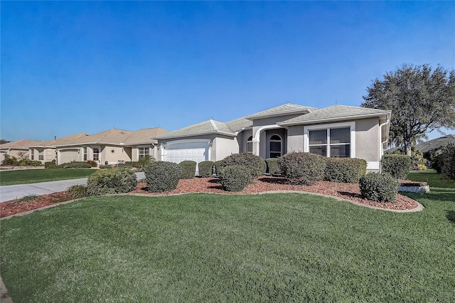 view of front of house with a front yard, an attached garage, and stucco siding