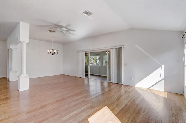 unfurnished living room with ceiling fan with notable chandelier, light wood finished floors, decorative columns, and visible vents