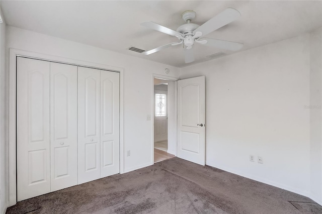 unfurnished bedroom with carpet floors, a ceiling fan, visible vents, and a closet