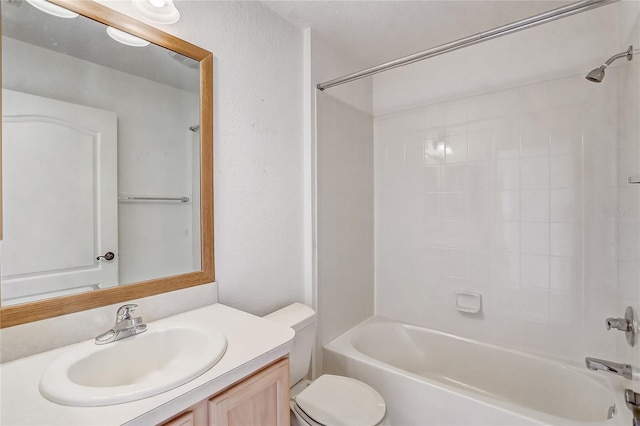 bathroom with washtub / shower combination, vanity, and toilet