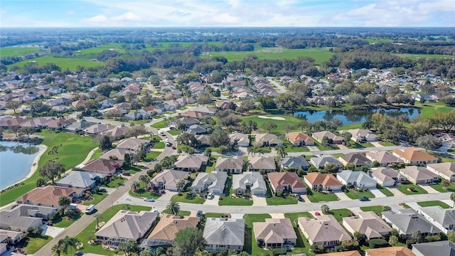 bird's eye view featuring a water view and a residential view