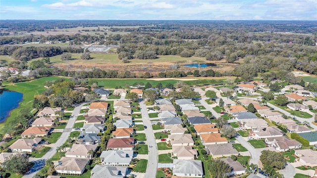 aerial view featuring a water view, view of golf course, and a residential view