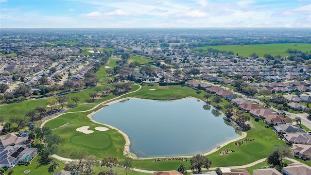 drone / aerial view with a residential view, a water view, and golf course view