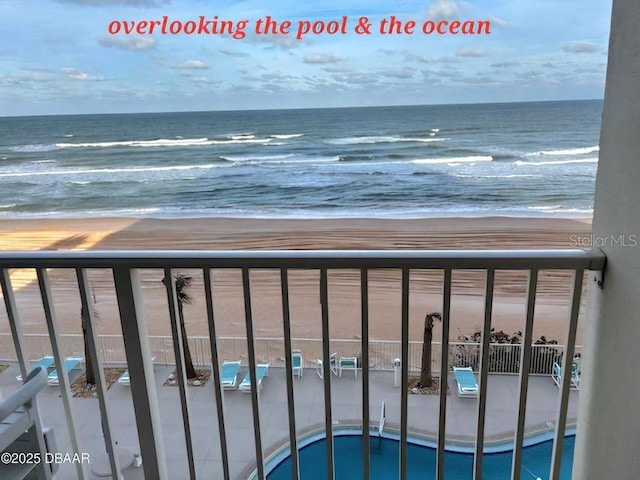 balcony featuring a beach view and a water view