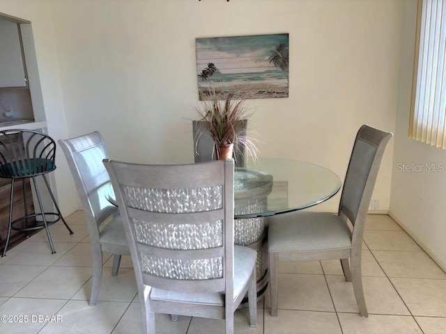 dining space with light tile patterned floors and baseboards