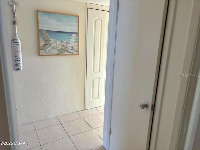 corridor with light tile patterned flooring