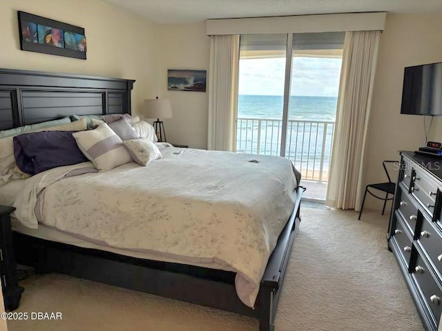 bedroom with access to outside and light colored carpet