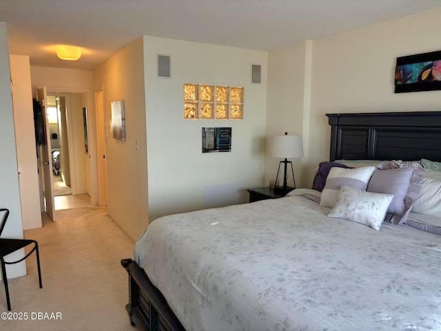 bedroom featuring light colored carpet