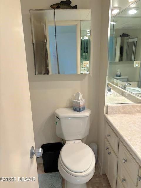 bathroom featuring vanity and toilet