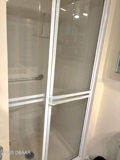 full bath featuring a shower stall