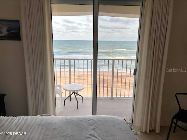 bedroom with a beach view and a water view